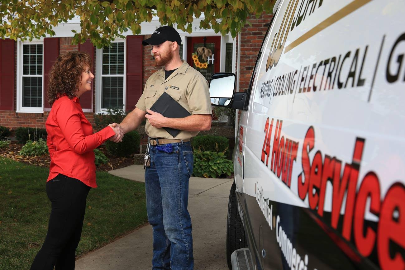 Happy customer shaking HVAC technician's hand